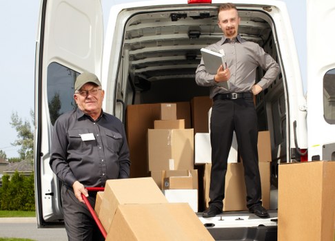 Removal team loading household furniture for a move in Ruxley