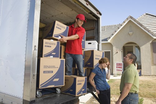 Professional movers handling household furniture and packing for a move in Ruxley