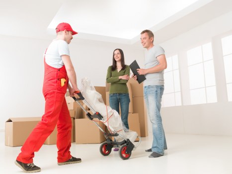 Team coordinating an office relocation with boxes, desks, and equipment