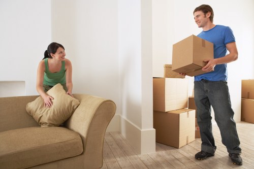 Careful loading of household items into a van for transport